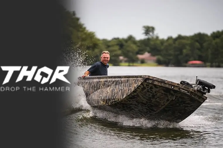 Thor camo boat splashing through water